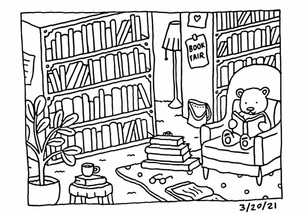 Cozy Bobbie Goods bear relaxing in a comfortable armchair while reading in a warm library filled with books.
